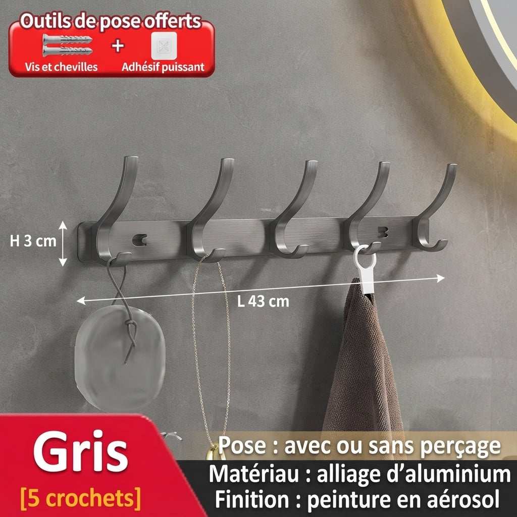 Grey five-hook brushed metal coat rack with loofah and towel on textured wall