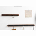 Two-tier wall-mounted coat rack setup with four and five hooks displaying storage