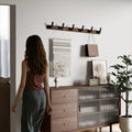 Five-hook wooden coat rack styled in mid-century modern living room