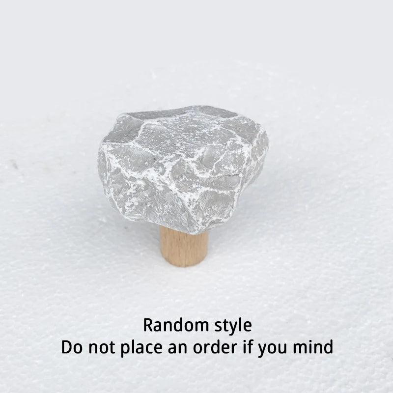 Irregular grey limestone wall hook on light wood base with random style note